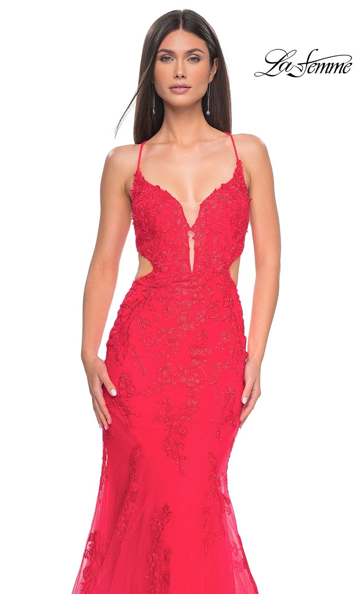 Model wearing the La Femme Long Lace Mermaid Prom Dress 31133, featuring bright red fitted lace, thin straps, side cutouts, and floral embroidery. White background with
